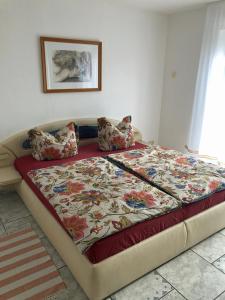 a bed with a blanket on it in a bedroom at Ferienwohnungen Familie Lang in Pirna