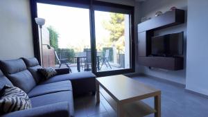 a living room with a couch and a large window at Casa D'Alessandro in Orihuela Costa