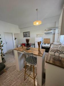 a kitchen with a table and a counter top at Beach apartment Edem first floor in Perivolos +43 photos