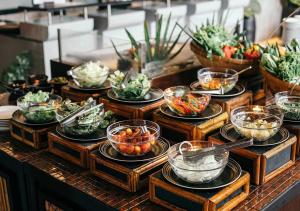 uma linha de buffet com tigelas de vegetais e outros pratos em The Dewa Koh Chang em Ko Chang