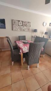 a dining room with a table and two chairs and a table and chairsktop at Casa Donn - El Sultán 63 - luxury 3 bed Villa with fast fibre internet in Corralejo