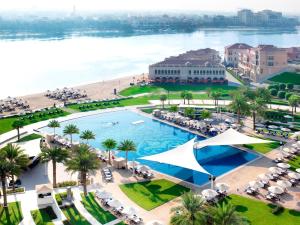 an aerial view of a resort with a pool and a beach at The Ritz-Carlton Abu Dhabi, Grand Canal in Abu Dhabi