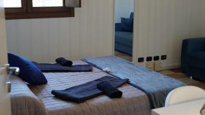a bed with blue sheets and pillows on it at Destiny Home 7 Verona Fiera in Verona