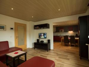 a living room with a couch and a dining room at Fewo am Hochscheid in Sankt Ingbert