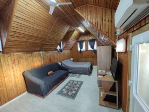 salon z kanapą i łóżkiem w przyczepie w obiekcie Casa cu Terase w mieście Syhot Marmaroski