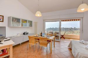 een keuken en woonkamer met een tafel en stoelen bij Residence Kormorano Malcesine Apt 52 in Malcesine