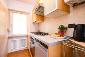 a kitchen with a stove and a plate of food on the counter at Residence Kormorano Malcesine Apt 52 in Malcesine