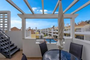 a view from the balcony of a condo with a table and chairs at Penthouse Papoila in Cabanas de Tavira