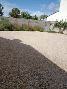 a shadow of a fire hydrant on a driveway at MAISON DE VACANCES in Saint-Vincent-sur-Jard