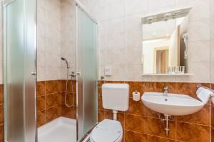 a bathroom with a toilet and a sink and a shower at Apartments Mirica 2 in Baška +15 photos
