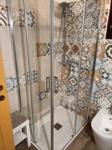 a shower with a glass door in a bathroom at Aromi di casa in Pianella