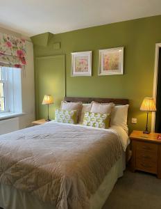 a bedroom with a bed with two lamps and a window at The Bell at Old Sodbury in Chipping Sodbury