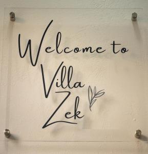 Una señal que dice bienvenida a Villa Zele en VillaZek a modern 2 bedroom open- plan apartment with parking, en Pretoria