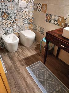 a bathroom with a sink and a toilet and tiles at Aromi di casa in Pianella +46 photos