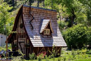a small house with a roof with a window at Camping La Ferme de Castellane in Castellane