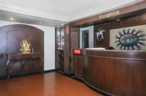 a lobby with a bar in a hotel at Octave Bund Garden in Pune