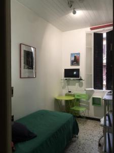 a bedroom with a bed and a desk and a television at Bastia Room in Bastia