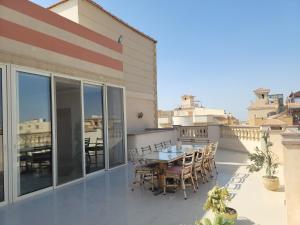 a patio with a table and chairs on a balcony at Rooftop Apartment with Terrace in Cairo