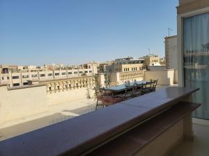 a table and chairs on the roof of a building at Rooftop Apartment with Terrace in Cairo