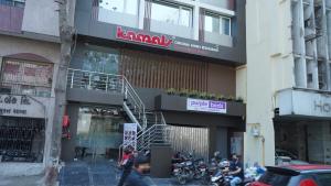 a group of motorcycles parked in front of a building at Purple Beds by VITS - Dwarkesh, Surat in Salabatpura