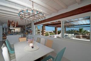 a kitchen and dining room with a table and chairs at Nefeli Sea View Holiday House in Mýkonos City