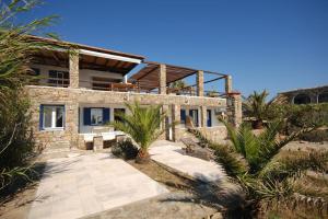 a stone house with a pathway in front of it at Nefeli Sea View Holiday House in Mýkonos City