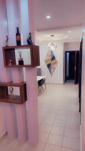 a living room with pink and white walls and a table at Exquisite 2-Bedroom Apt in Oniru in Lagos