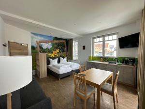 a living room with a table and a couch at Urlaubshaus-Erzgebirge in Zwönitz