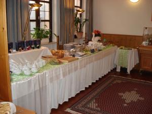 a long table in a room with white table cloth at Gasthof zur Schwane in Abtswind