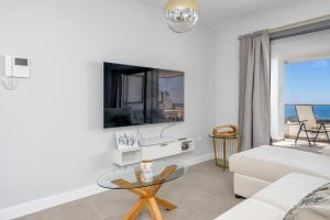 a living room with a white couch and a glass table at Luxurious apartment in Benalmadena Ref 35 in Benalmádena