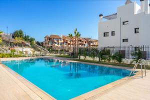 a swimming pool in front of a building at Modern apartment with pool in Benalmadena Ref 47 in Benalmádena