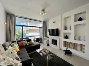 a living room with a couch and a fireplace at Vilamoura Prestige With Pool by Homing in Vilamoura