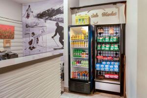 a refrigerator filled with lots of drinks in a store at La Quinta Inn by Wyndham Steamboat Springs in Steamboat Springs