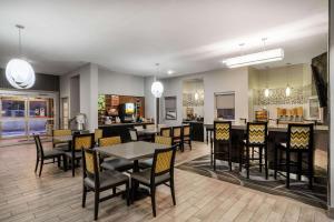 a dining room and kitchen with a table and chairs at La Quinta Inn by Wyndham Steamboat Springs in Steamboat Springs