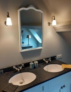 a bathroom with two sinks and a mirror at B&B In 't Stille Weg in Kemmel