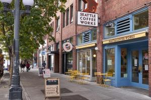 a street with tables and chairs outside of a coffee shop at Downtown 1BR w Gym Roof WD nr Pike Pl Mkt SEA-239 in Seattle