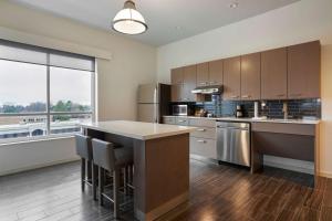 a kitchen with a counter and a large window at Hyatt House Louisville East in Louisville