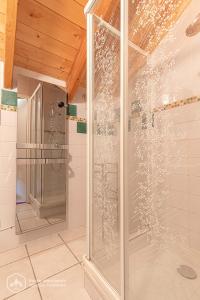 a shower with a glass door in a bathroom at Chalet Deleglise 1 in Valfréjus