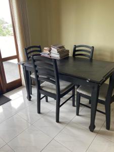 una mesa negra y sillas con libros encima en Kenz Villa en Colombo