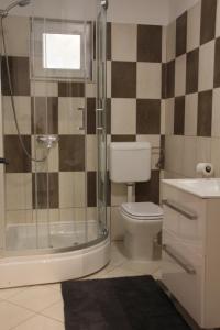a bathroom with a shower and a toilet and a sink at Apartment Orebic 4526b in Orebić