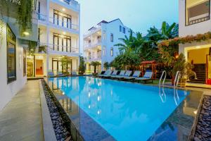 a swimming pool in the middle of a building at Banana Garden Hoi An in Hoi An