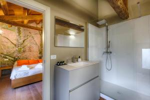 a bathroom with a sink and a shower and a bed at Agriturismo La Vigna di Sarah in Vittorio Veneto