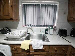 a kitchen counter with a sink and a window at Exquisite Two Bed Apartment in Grays - Free Wi-Fi and Netflix in Stifford