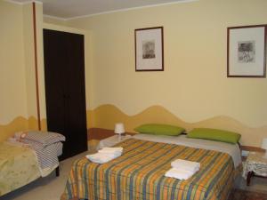 a bedroom with a bed with two green pillows at B&B Casa Ferrara in Monopoli