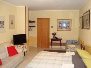 a living room with a couch and a tv at B&B Casa Ferrara in Monopoli