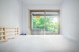 A bed or beds in a room at Luminoso apartamento cerca de la playa