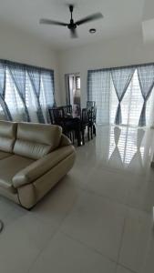 a living room with a couch and a dining room at Homestay Nilai D'Jati in Nilai