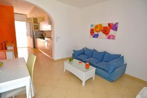 a living room with a blue couch and a table at Casa Sammali in Torre Vado