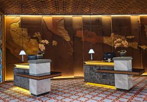 a lobby with two reception desks and a map of the world at The Singhasari Resort Batu in Batu