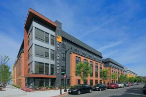 a building on a street with cars parked in a parking lot at S Boston 1BR w Gym WD by Seaport Lawn on D BOS-335 in Boston